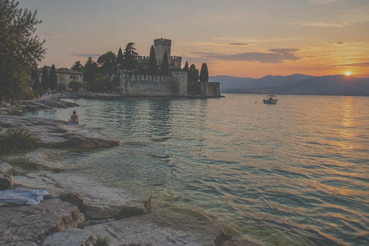 The Sirmione peninsula reaching into Lake Garda under a clear evening sky