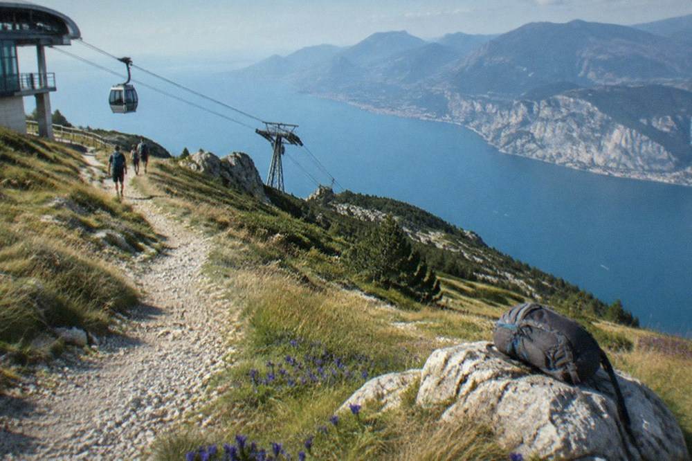 Walking path along the Monte Baldo ridge with the lake far below